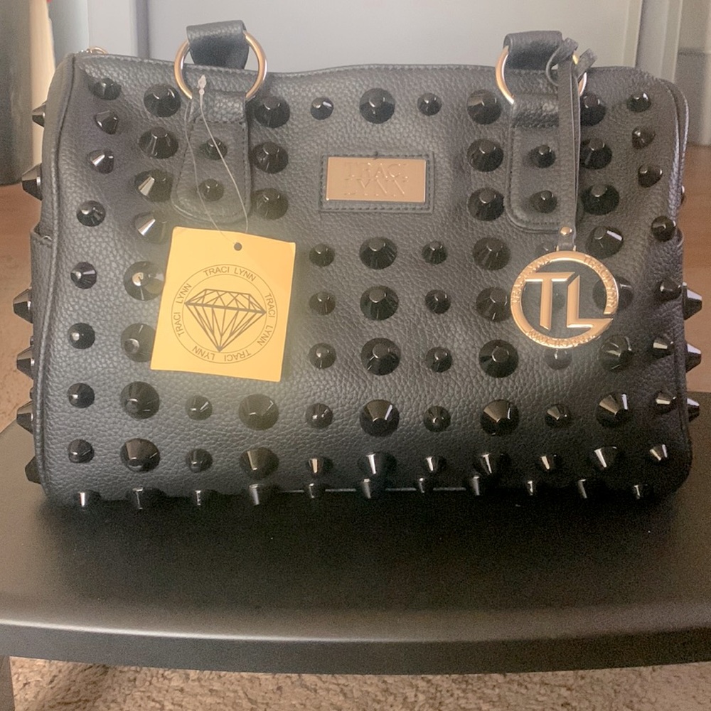 Black handbag with black studs; also comes with shoulder strap